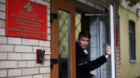 A young man leaves a military enlistment office in Moscow.