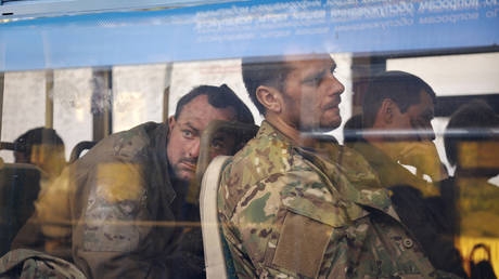 FILE PHOTO: Captured Ukrainian servicemen sit in a bus after they were evacuated from the Azovstal steel plant in Mariupol, Ukraine, May 17, 2022