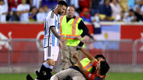 Messi was almost taken down as security staff intervened.