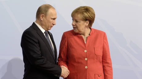 FILE PHOTO: Vladimir Putin and Angela Merkel.