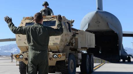 FILE PHOTO: American soldiers move an M142 High Mobility Artillery Rocket System (HIMARS) onto a C-17 Globemaster III cargo aircraft, in Fort Carson, Colorado.