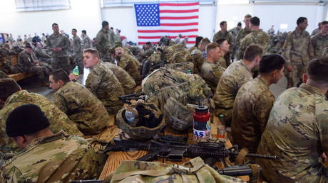 Soldiers with the 82nd Airborne division wait to deploy to Poland on February 14, 2022 in Fort Bragg, North Carolina.