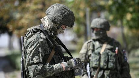 FILE PHOTO: Russian servicemen measure the radiation level at the Zaporozhye nuclear power plant.