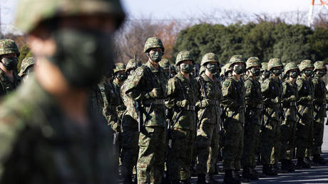 Members of the Japan Self-Defense Forces (JSDF) stand as they listen to Prime Minister Fumio Kishida during a review at the Japan Ground Self-Defense Force’s Camp Asaka on November 27, 2021, Tokyo, Japan
