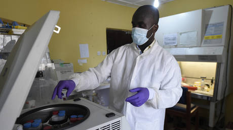 FILE PHOTO. A health official works in the laboratory extraction room of the Institute of Lassa Fever Research and Control in Irrua, Nigeria.