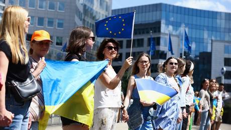 Demonstrators hold Ukrainian flags during a rally outside the headquarters of the European Commission in Brussels.