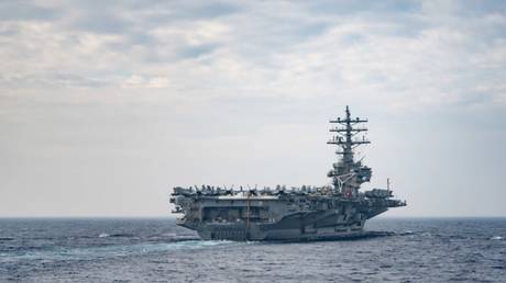 FILE PHOTO: The US aircraft carrier USS Ronald Reagan conducts routine operations in the Philippine Sea, May 30, 2020.
