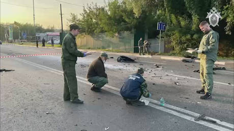 Russian officials investigate the scene after the car of Darya Dugina, daughter of Alexander Dugin, Russian political scientist and ally of President Vladimir Putin exploded on Mozhayskoye highway in Moscow, Russia on August 21, 2022.