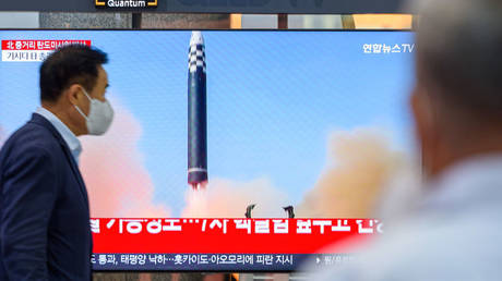 A TV screen showing a news program about a North Korean missile launch at a railway station in Seoul. October, 2022