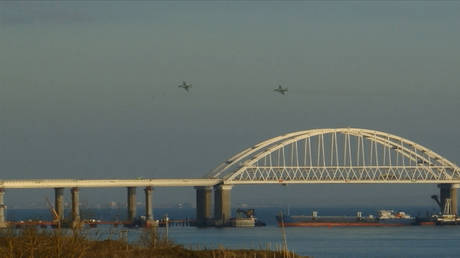 FILE PHOTO: Russian aircraft flying over the Crimean Bridge that spans the Kerch Strait.