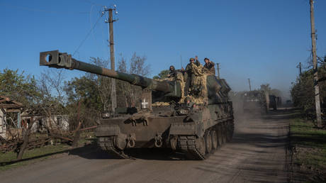 Ukrainian soldiers ride on a Polish Krab self-propelled howitzer on October 08, 2022 in Rubtsi, Ukraine.