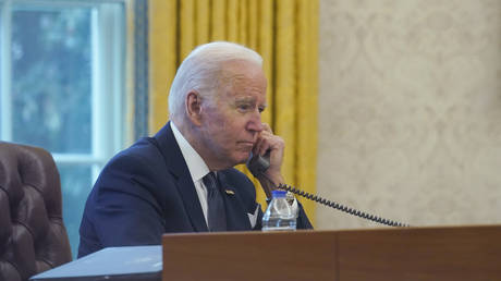 FILE PHOTO: Joe Biden talks on the phone with Ukrainian President Vladimir Zelensky at the White House in Washington, DC, Decemberb 9, 2021