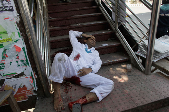 An activist, from one of the 12 Islamist parties involved in a clash, lies by an overhead bridge after being injured by a rubber bullet shot by the police in Dhaka February 22, 2013.(Reuters / Andrew Biraj)