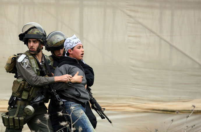 Israeli border police detain a Palestinian demonstrator following clashes at the entrance of the Jalama checkpoint, near the West Bank city of Jenin, on February 22, 2013.(AFP Photo / Saif Dahlah)