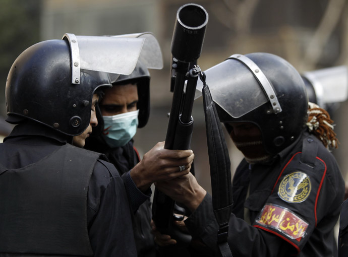 Riot policemen prepare to release tear gas at protesters opposing Egyptian President Mohamed Mursi during clashes along Simon Bolivar Square, which leads to Tahrir Square, in Cairo January 30, 2013. (Reuters/Amr Abdallah Dalsh)