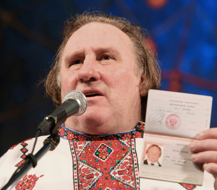 French actor Gerard Depardieu, who was granted Russian citizenship, showing his Russian passport while wearing a Mordovian national shirt at the Theater of Opera and Ballet in Saransk. (RIA Novosti/Julia Chestnova)