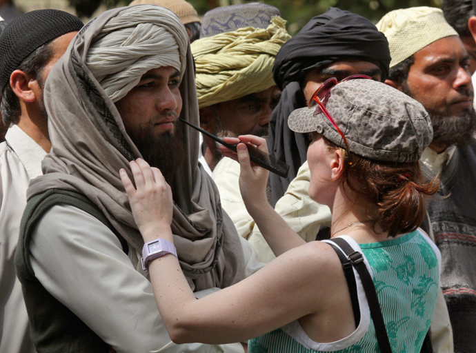 A crew member of Oscar-winning director Kathryn Bigelow's team for the movie "Zero Dark Thirty" applies makeup on an actor during a shoot at the filming location in the northern Indian city of Chandigarh March 17, 2012 (Reuters / Ajay Verma)