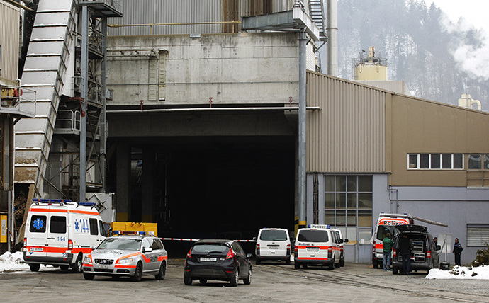 Police and rescue service vehicles are seen in front of the wood processing plant of Kronospan following a shooting in Menznau near Lucerne February 27, 2013. (Reuters / Michael Buholzer)