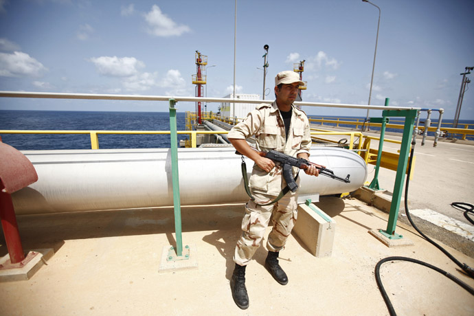 An anti-Gaddafi fighter stands guard at the Mellitah Oil and Gas complex during a handover ceremony in Mellitah, 80 km west Tripoli September 6, 2011. (Reuters/Zohra Bensemra)