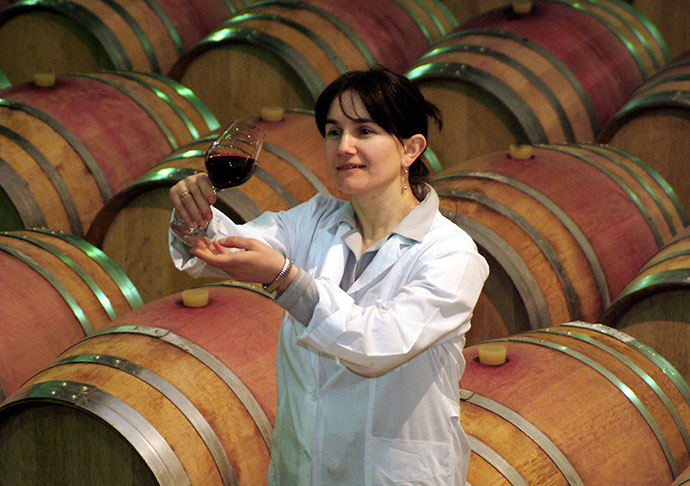 A Georgian specialist holds up a glass of wine at a vineyard in Telavi in eastern Georgia. (Reuters)