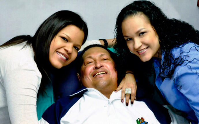 Venezuela's President Hugo Chavez smiles in between his daughters, Rosa Virginia (R) and Maria while recovering from cancer surgery in Havana on February 15, 2013 (Reuters / Ministry of Information / Handout)