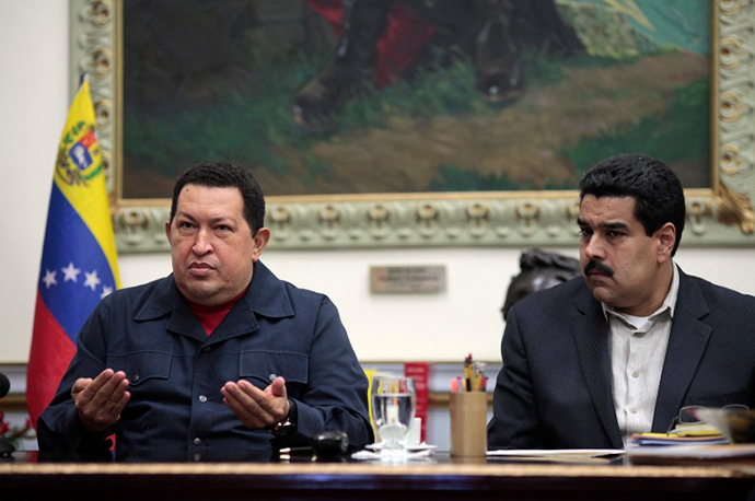 Venezuala's President Hugo Chavez gesturing as he sits next to Vice presidente Nicolas Maduro during a televised radio event in Caracas on 8 December, 2012. (AFP Photo / Presedencia)