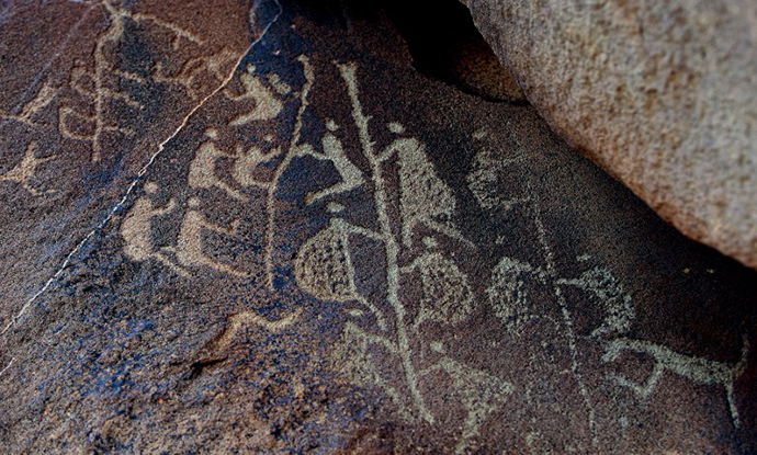 The ancient Aboriginal rock carving known as 'Climbing Man', believed to be thousands of years old is shown in this photo taken on the Burrup Peninsula in the north of Western Australia. (AFP Photo / Greg Wood)