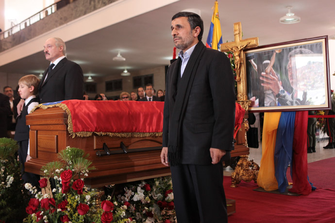 This handout picture released by Venezuelan presidency press office shows Iranian President Mahmoud Ahmadinejad(R) and Belarus President Aleksandr Lukashenko paying their respects at the coffin of late Venezuelan President Hugo Chavez in Caracas, on March 8, 2013. (AFP Photo/Presidencia/Miguel Angel Angulo)