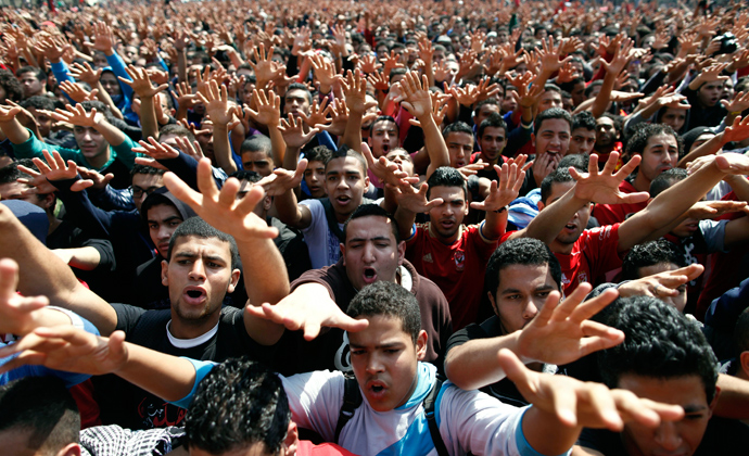 Egyptian al-Ahly football club supporters (Ultras) wave their hands as they celebrate in Cairo on March 9, 2013 (AFP Photo / Mahmud Khaled)