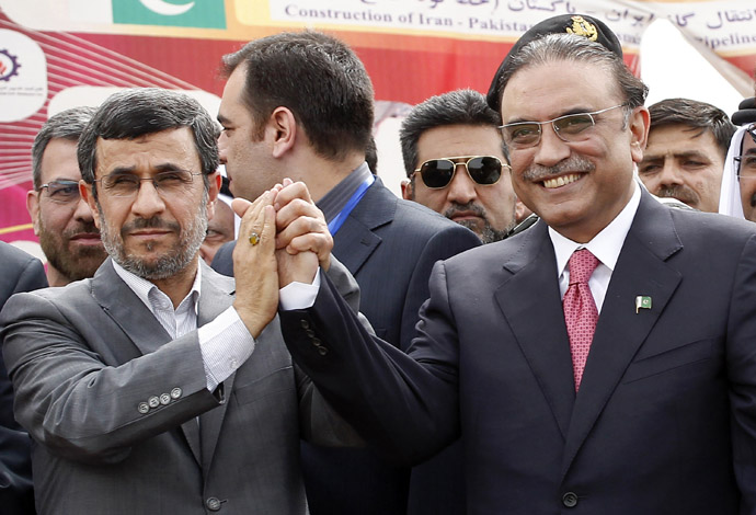 Iran's President Mahmoud Ahmadinejad (L) shakes hands with his Pakistani counterpart Asif Ali Zardari during a groundbreaking ceremony to mark the inauguration of the Iran-Pakistan gas pipeline, in the city of Chahbahar in southeastern Iran March 11, 2013. (Reuters/Mian Khursheed)