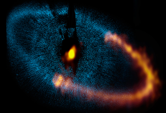This view shows a new picture of the dust ring around the bright star Fomalhaut obtained by ALMA. The underlying blue picture is an earlier view obtained by the Hubble. Credit: ALMA (ESO/NAOJ/NRAO). Visible light image: the NASA/ESA Hubble Space Telescope 