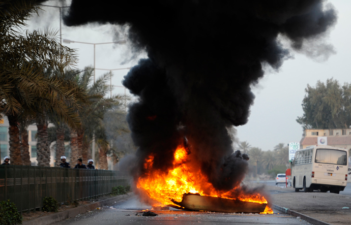 A boat is set on fire by anti-government protesters to act as a road block as riot police arrive to remove it during early hours of clashes in Budaiya, west of Manama March 14, 2013 (Reuters / Hamad I Mohammed)