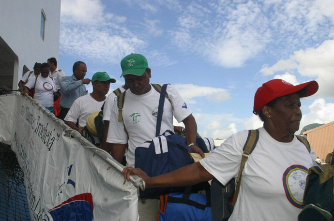 Chagosians disembark at Peros Banos Island 10 April 2006. (AFP Photo / Ali Soobye)