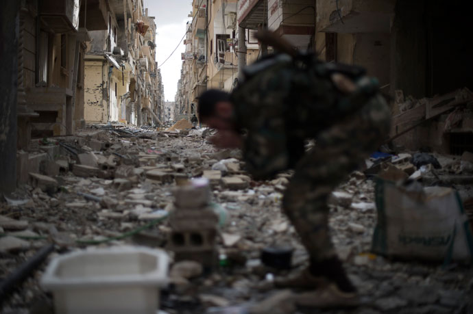 A Syrian opposition fighter rubs dust from his face in the Jabilleh neighbourhood of the eastern city of Deiz Ezzor, during clashes with regime forces as they try to retake the area on February 16, 2013.(AFP Photo / Zac Baillie)