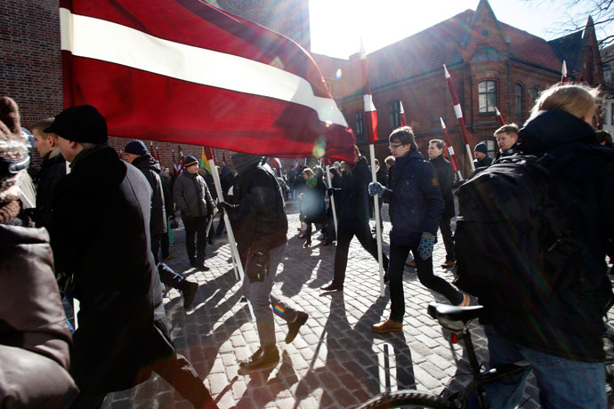 People hold Latvian national flags during the annual procession commemorating the Latvian Waffen-SS (Schutzstaffel) unit, also known as the Legionnaires, in Riga March 16, 2013.(Reuters / Ints Kalnins)