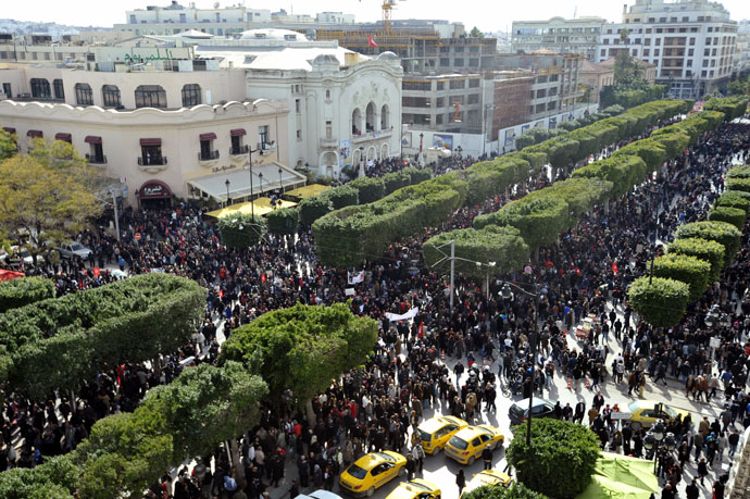 Tunisian people take part in a demonstration to mark the 40th day of mourning after the death of anti-Islamist opposition leader Chokri Belaid (featured on poster) on March 16, 2013.(AFP Photo / Fethi Belaid)