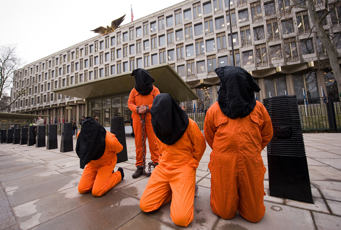  Protestors wear suits similar to those worn by detainees at Guantanamo Bay prison during a demonstration in central London (AFP Photo / Leon Neal)