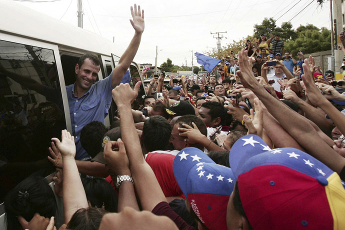 Venezuela's opposition leader and presidential candidate Henrique Capriles (L) greets supporters during a rally in Maracaibo March 17, 2013. (Reuters/Isaac Urrutia)