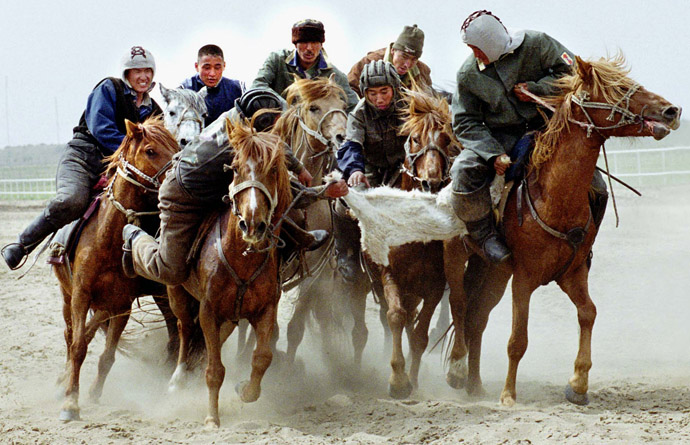 Two teams of Kazakh riders fight for a goat's body during a game of the national sport, kokpar, in Pavlodar, May 13, 2001. (Reuters)