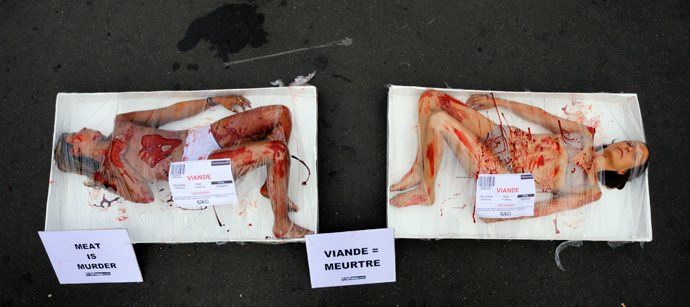 PETA (People for the Ethical Treatment of Animals) activists protest on a pavement in packaging labelled 'meat' in Paris (Reuters / Philippe Wojazer)