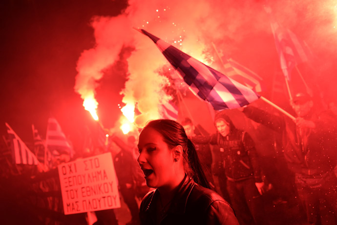 Some of about 1,000 members of the ultra-nationalist Golden Dawn party hold flares while chanting the Greek national anthem on March 22, 2013 outside the German Embassy in Athens against the EU austerity plans for Cyprus. (AFP Photo/Aris Messinis)