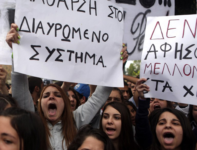 Cypriot college students shout slogans outside the parliament during a protest in Nicosia against a bailout for the financially crippled island on March 26, 2013. (AFP Photo / Patrick Baz)