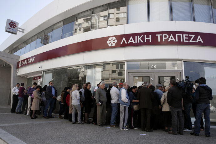 Customers queue up outside a branch of Laiki Bank as they wait for the reopening of the bank in Nicosia March 28, 2013. (Reuters/Yorgos Karahalis)