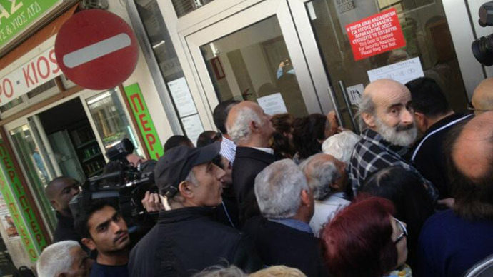 Cyprus reopens banks with strict limits on transactions