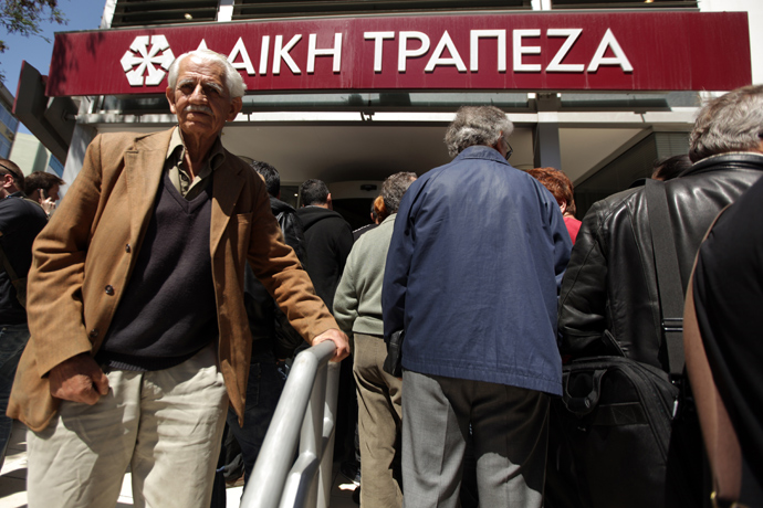 People queue up outside a Laiki bank branch in the Cypriot capital, Nicosia, on March 28, 2013, as they wait for the bank to open after an unprecedented 12-day lockdown (AFP Photo / Patrick Baz)