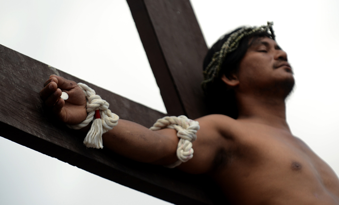 A penintent is nailed to a cross during the reenactment of crucifixion on Good Friday in the village of San Juan, San Fernando City, north of Manila on March 29, 2013 (AFP Photo / Noel Celis)