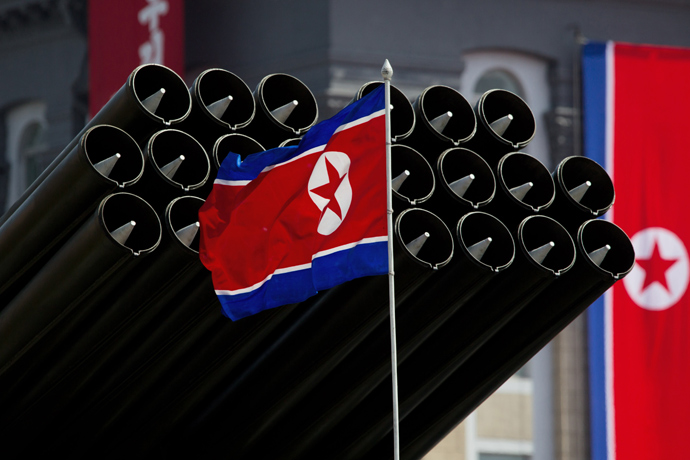 A North Korean flag flies before missiles displayed (AFP Photo / Ed Jones)