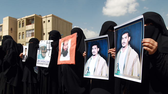 Relatives of Yemeni inmates held in the US detention center "Camp Delta" at the US Naval Base in Guantanamo Bay, Cuba, brandish their portraits during a protest to demand their release, outside the American Embassy in Sanaa, on April 1, 2013 (AFP Photo / Mohammed Huwais)
