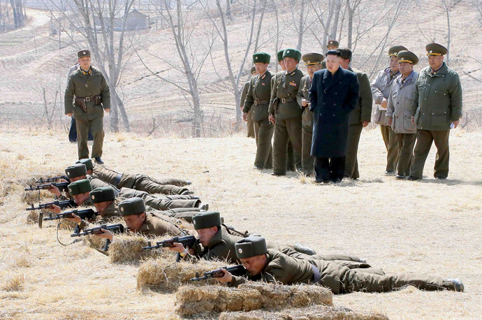 This photo taken on March 23, 2013 and released by North Korea's official Korean Central News Agency (KCNA) on March 24 shows North Korean leader Kim Jong-Un (4th R-in blue) inspecting the second battalion under Korth Korean army Unit 1973 at an undisclosed location. (AFP Photo/KCNA via KNS)