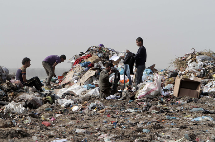 Palestinians go through a pile of garbage in search of recyclable material in Rafah in the southern Gaza Strip on April 3, 2013. (AFP Photo/Said Khatib)